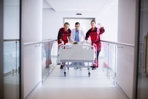doctors-pushing-emergency-stretcher-bed-corridor