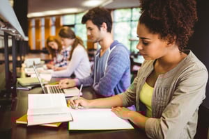focused-students-sitting-line-writing