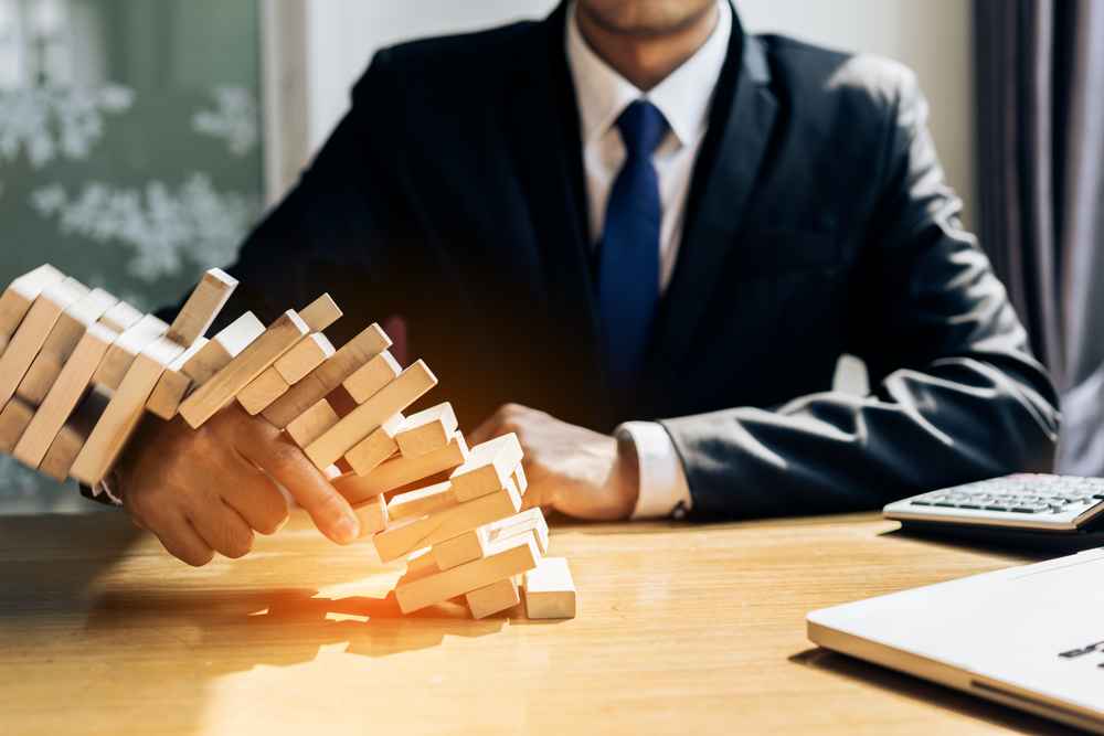 midsection-businessman-holding-wooden-blocks-office-desk